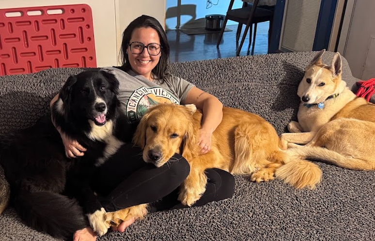 A member of the Dog Friends family relaxing at home with three happy dogs